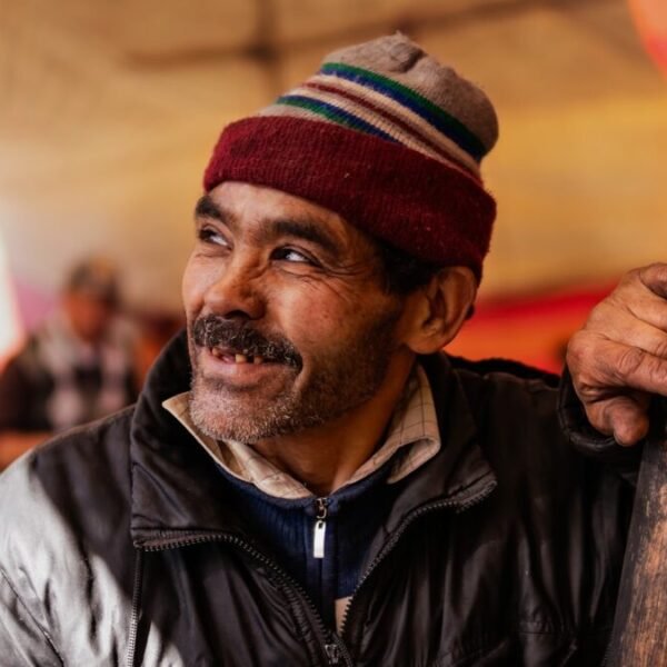 man in black leather jacket wearing red and white knit cap