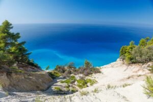a view of the ocean from the top of a hill