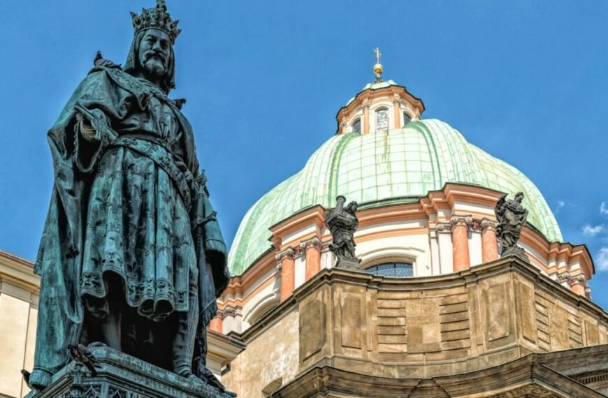 a statue stands in front of a domed building